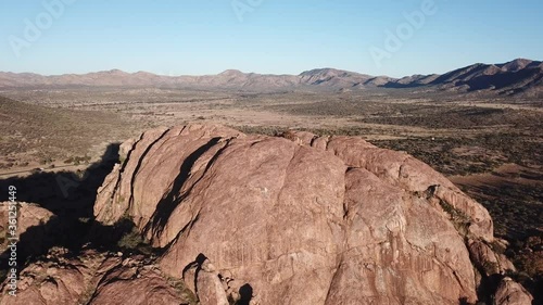 4K aerial drone video of African savanna hills, large red granite boulders range near B1 highway south of Windhoek in central highland Khomas Hochland of Namibia, southern Africa