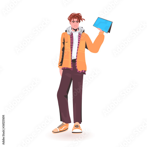 man holding tablet pc young guy model in trendy clothes male cartoon character standing pose full length isolated vector illustration
