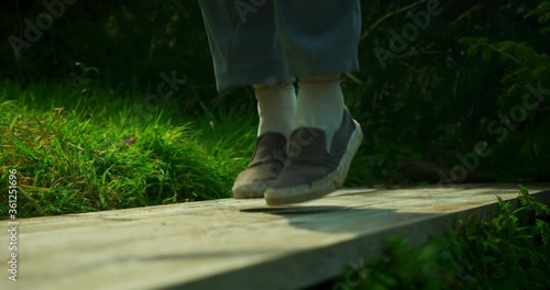 The feet of a young man skipping outsdoors photo