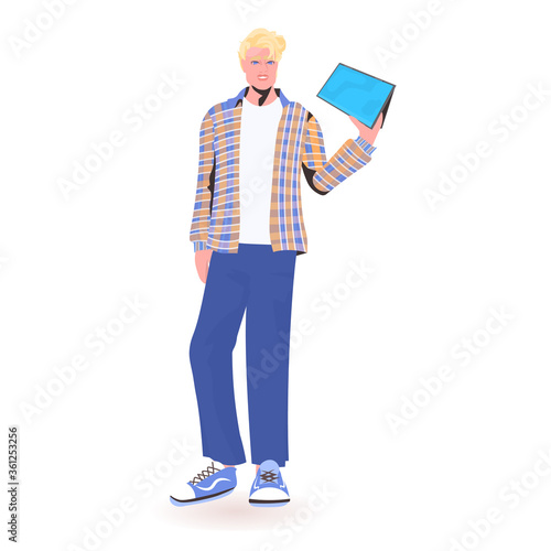 man holding tablet pc young guy model in trendy clothes male cartoon character standing pose full length isolated vector illustration