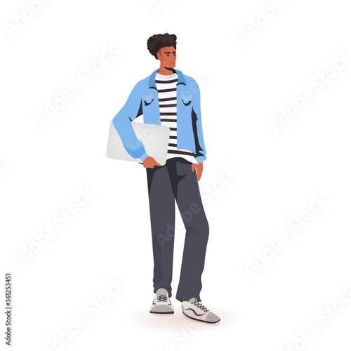 man holding laptop african american guy model in trendy clothes male cartoon character standing pose full length isolated vector illustration
