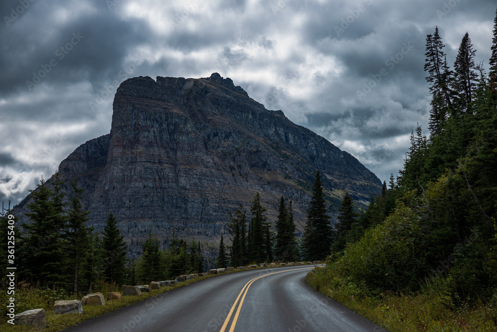 road in mountains with overcast sky, Heavy Runner Mountain in Glacier National Park, Montana