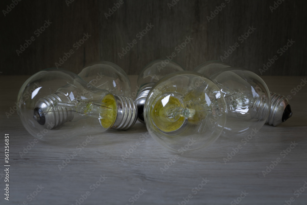 Light bulbs on bleached wood. Photo for the background on the topic of lighting or energy saving. Light bulbs on bleached wood. Photo for the background on the topic of lighting or energy saving.