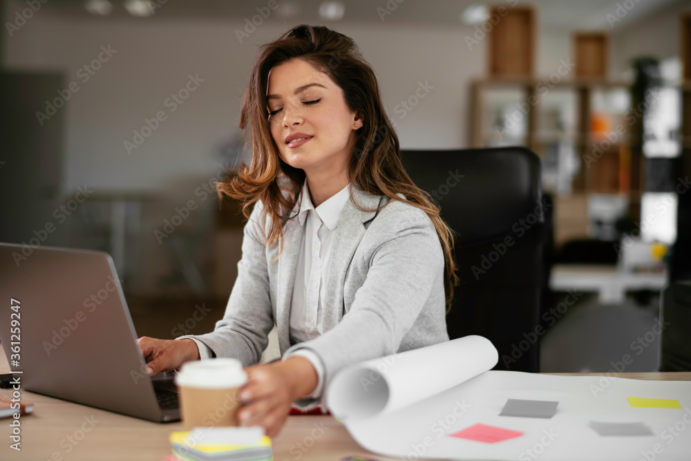 Beautiful young woman with cup of coffee. Woman enjoys fresh coffee in the morning on her desk at the office.
Beautiful young woman with cup of coffee. Woman enjoys fresh coffee in the morning on her desk at the office.