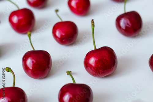 Layout, pattern of red cherry berries on a white background top view.