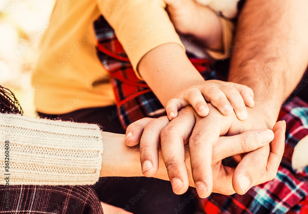 Concept of unity, support, protection, happiness. Parents hold the baby