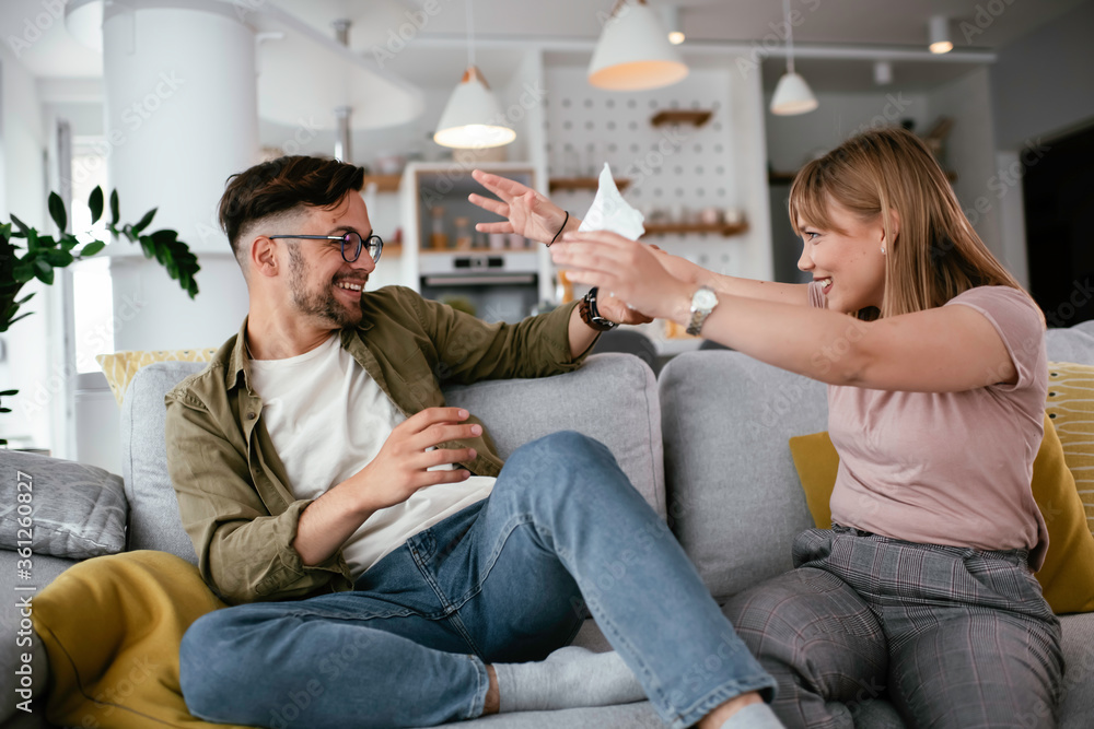 Young loving couple on the sofa. Happy couple talking in the living room. Young loving couple on the sofa. Happy couple talking in the living room.