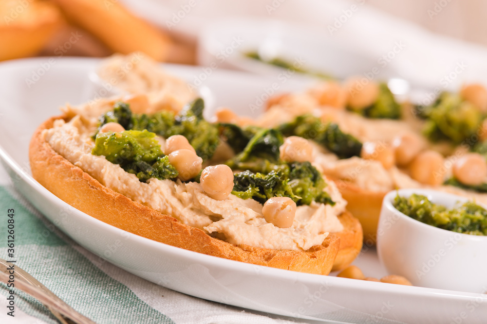 Friselle with turnip tops and hummus.
Friselle with turnip tops and hummus.