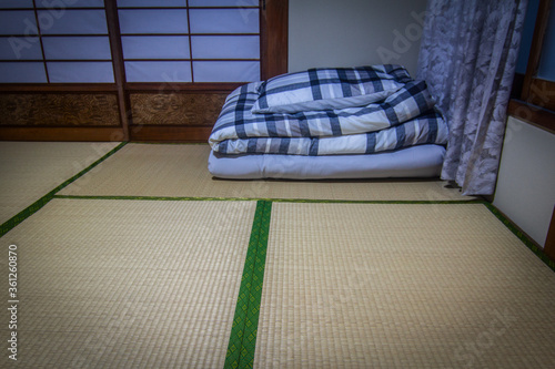 Closeup folded blanket or comforter and pillow on tatami. In traditional japanese culture, people sleep using futon on tatami