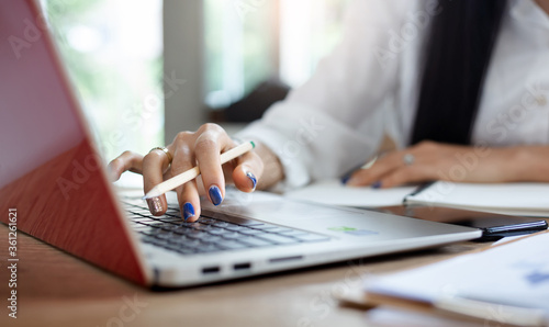 Close-up of hand young asian woman using laptop working and meeting online from home