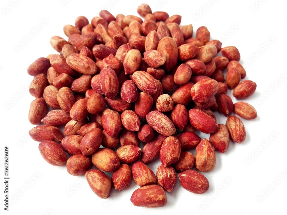 Peanut snacks groundnut heap isolated. Closeup red peanut, roasted groundnut snack pile. Eating peanuts snack concept macro. Peeled groundnut heap on white background. Salted peanuts with skin above Peanut snacks groundnut heap isolated. Closeup red peanut, roasted groundnut snack pile. Eating peanuts snack concept macro. Peeled groundnut heap on white background. Salted peanuts with skin above