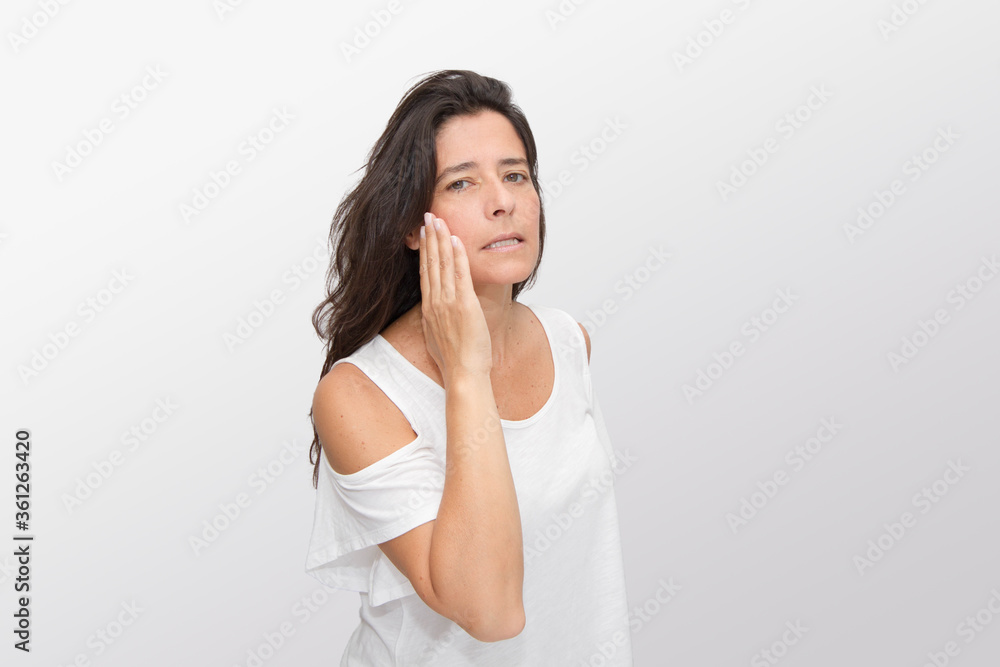 Very attractive and pretty middle-aged woman shows the skin of her face well preserved Very attractive and pretty middle-aged woman shows the skin of her face well preserved