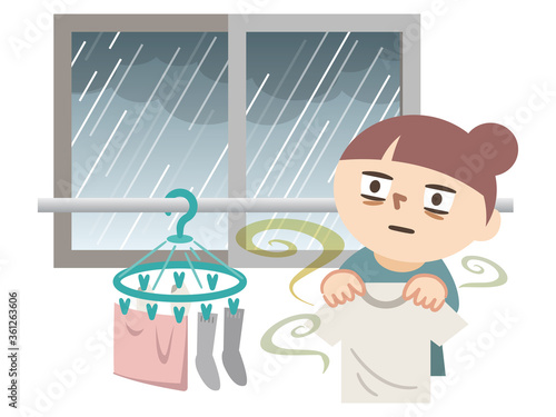 雨で洗濯物が干せずに呆然とする女性