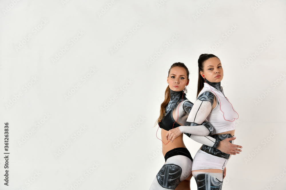 beautiful and warlike girls in robotic costumes as sisters are ready to protect each other beautiful and warlike girls in robotic costumes as sisters are ready to protect each other