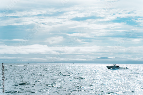 sea, boat and sky with clouds © Anna Rudoy