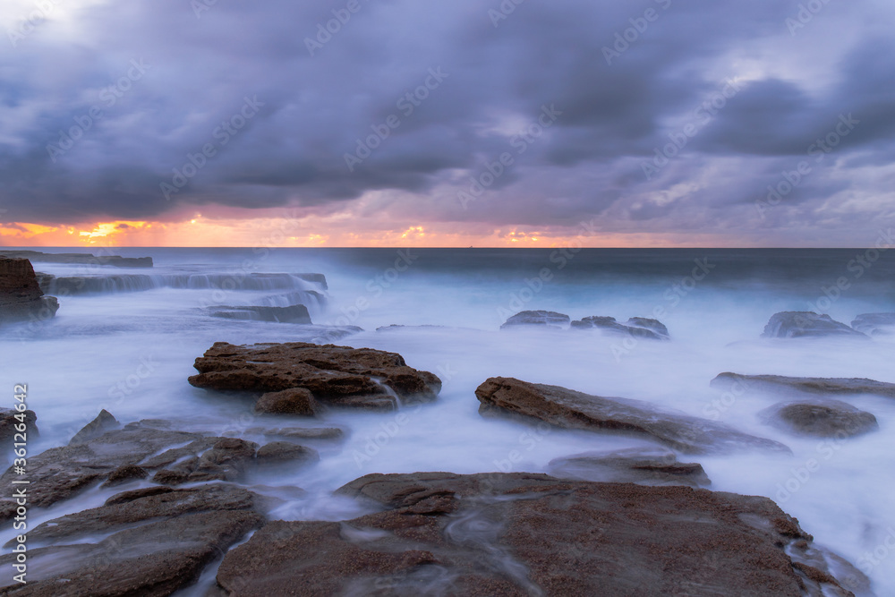 Naklejka premium Stormy morning sky over the coastline.