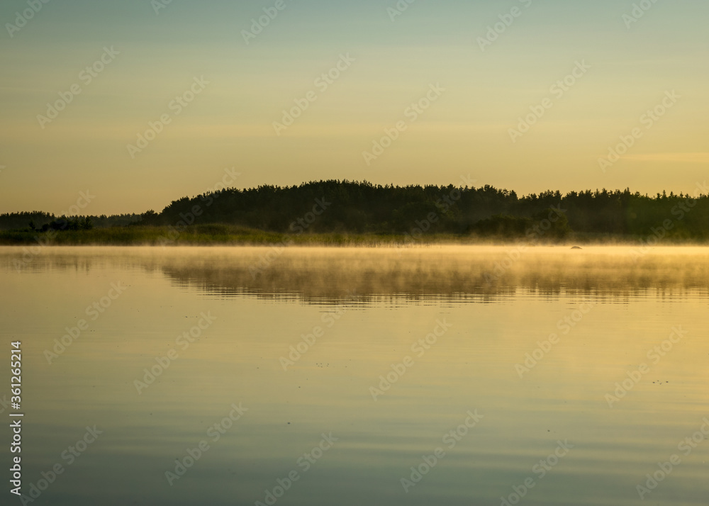 Foggy weather early in the morning on the lake. beautiful wallpapers. a mystical mist vibrates in the lake. summer sunrise