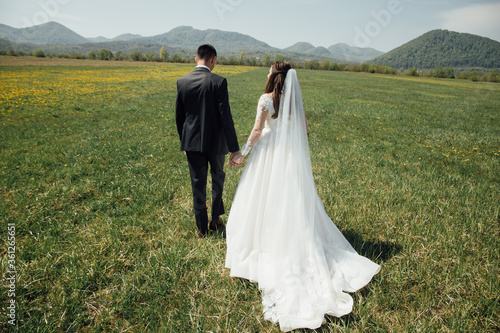 wedding couple on nature walks in the field with wheat. Fabulous rural landscapes