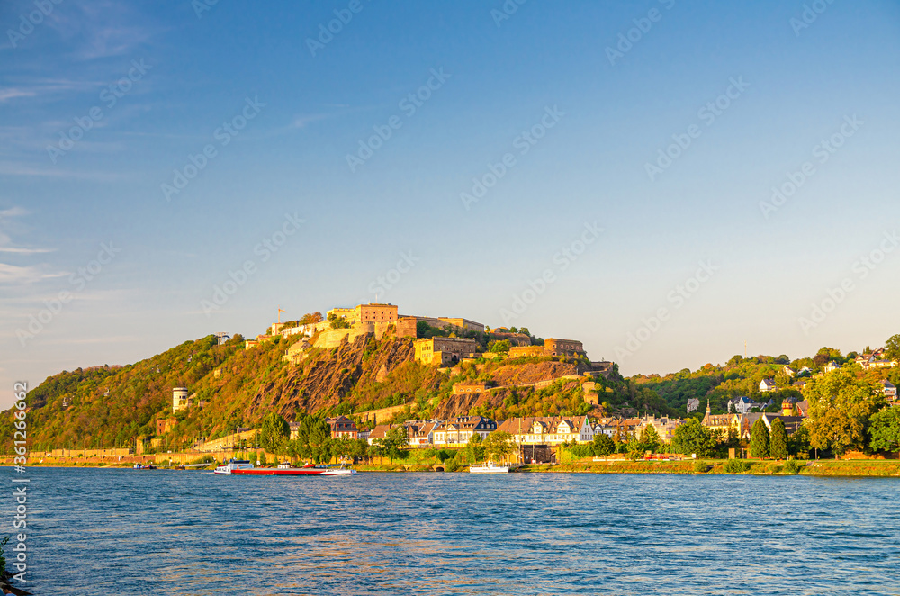 Ehrenbreitstein Fortress medieval building on hill of east steep bank of Rhine river, view from Koblenz city, blue sky background, Rhineland-Palatinate state, Germany