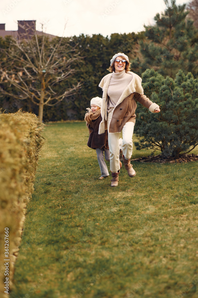 Obraz premium Family in a garden. Mother with daughter. People with little dog.