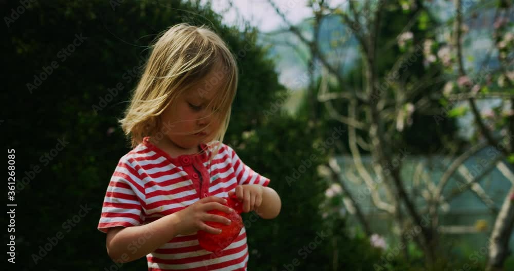Little preschooler boy blowing bubbles in the garden Little preschooler boy blowing bubbles in the garden