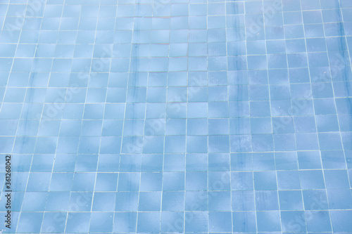 The blue tile floor of the pool