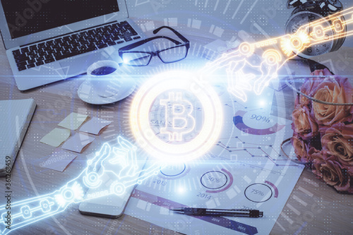 Double exposure of blockchain and crypto economy theme hologram and table with computer background. Concept of bitcoin cryptocurrency.