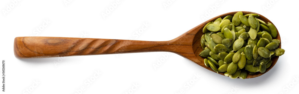 Wooden spoon with raw pumpkin seeds isolated on white Wooden spoon with raw pumpkin seeds isolated on white