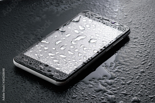 International Ingress Protection Rating - liquid water drops on glass of smartphone - ingress protection rating