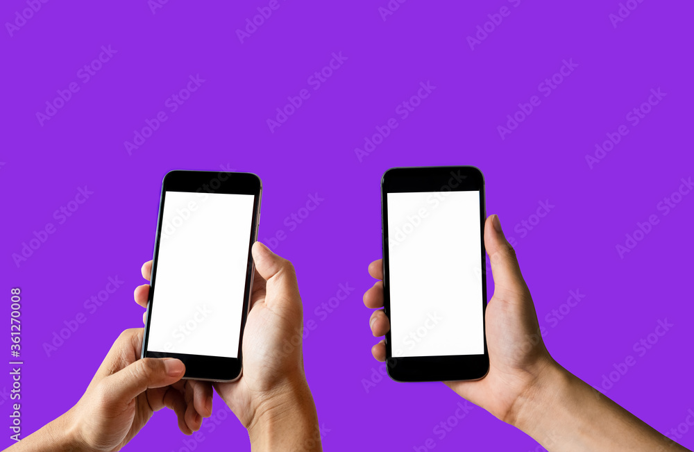 Female hand holding the black smartphone with blank screen and modern frameless design two positions angled and vertical - isolated on purple background. Female hand holding the black smartphone with blank screen and modern frameless design two positions angled and vertical - isolated on purple background.