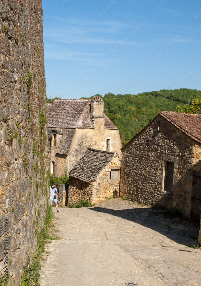 Typical French townscape with ancient housest and cobblestone street in the traditional town Beynac-et-Cazenac, France Typical French townscape with ancient housest and cobblestone street in the traditional town Beynac-et-Cazenac, France