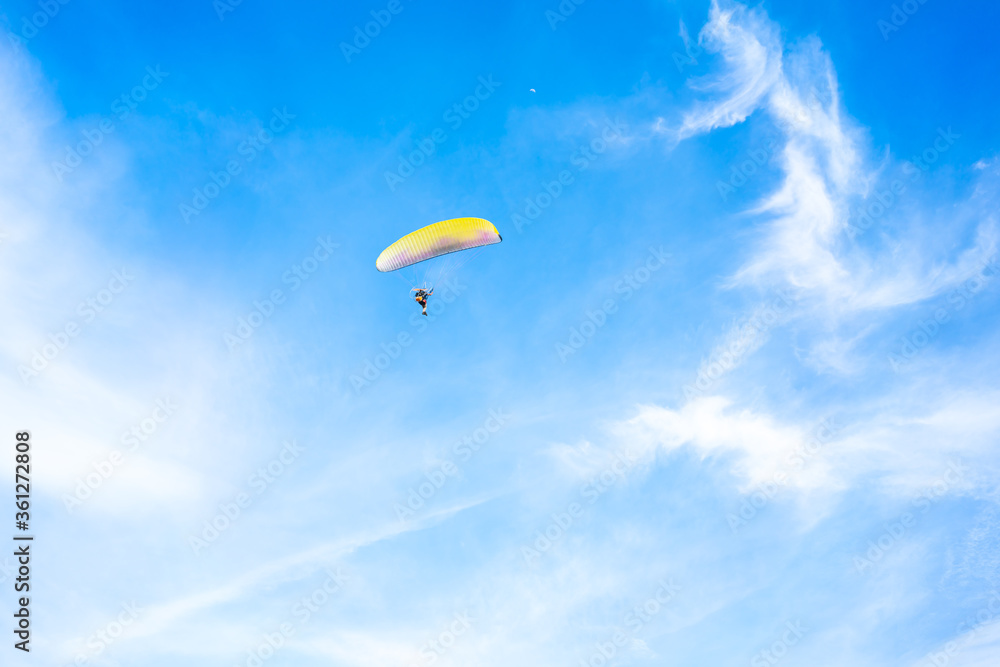 Fly on paramotor On the blue sky and white clouds Fly on paramotor On the blue sky and white clouds