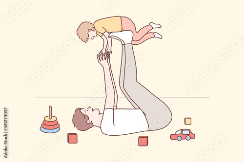 Family, fatherhood, childhood, play, recreation, leisure concept. Joyful young man dad lying on carpet floor lifting excited happy little child kid son at home.Having fun and fathers day illustration.