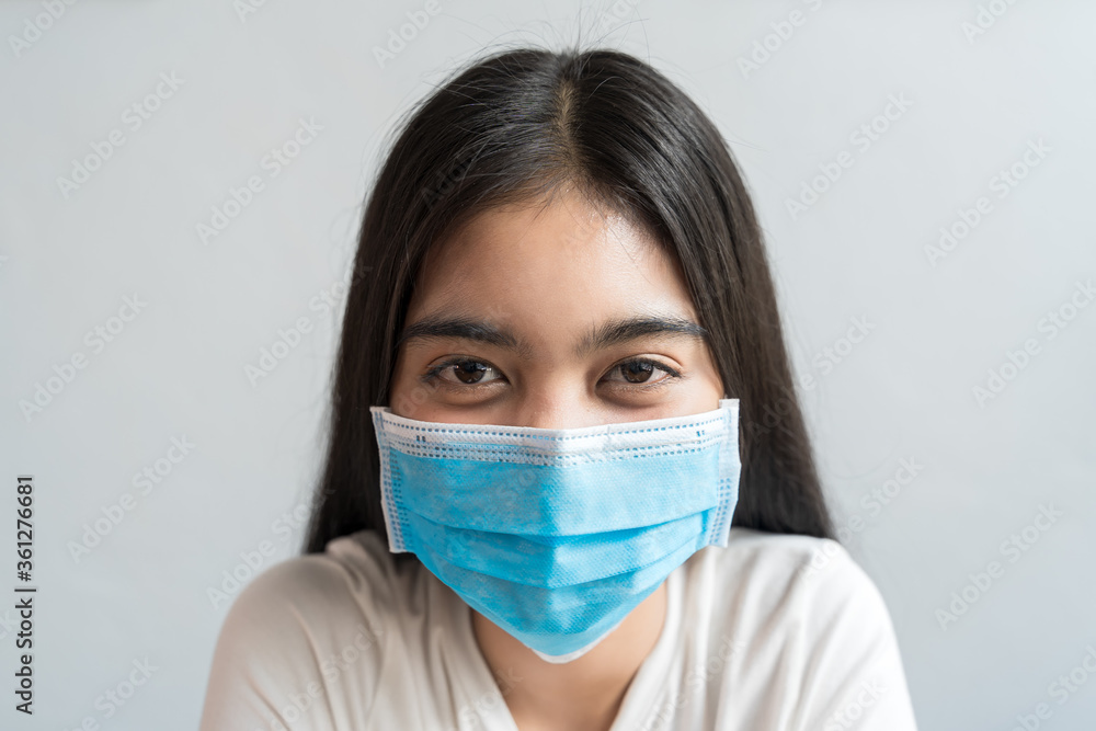 Close up face of Asian are wears a health mask and is smiling She has a fever or airborne dust protection healthy concept with copy space. Close up face of Asian are wears a health mask and is smiling She has a fever or airborne dust protection healthy concept with copy space.