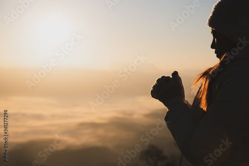 Religious young woman praying to God in the morning  spirtuality and religion  Religious concepts