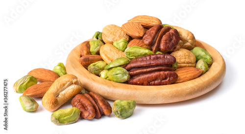 unsalted mixed nuts in the wooden plate, isolated on white background