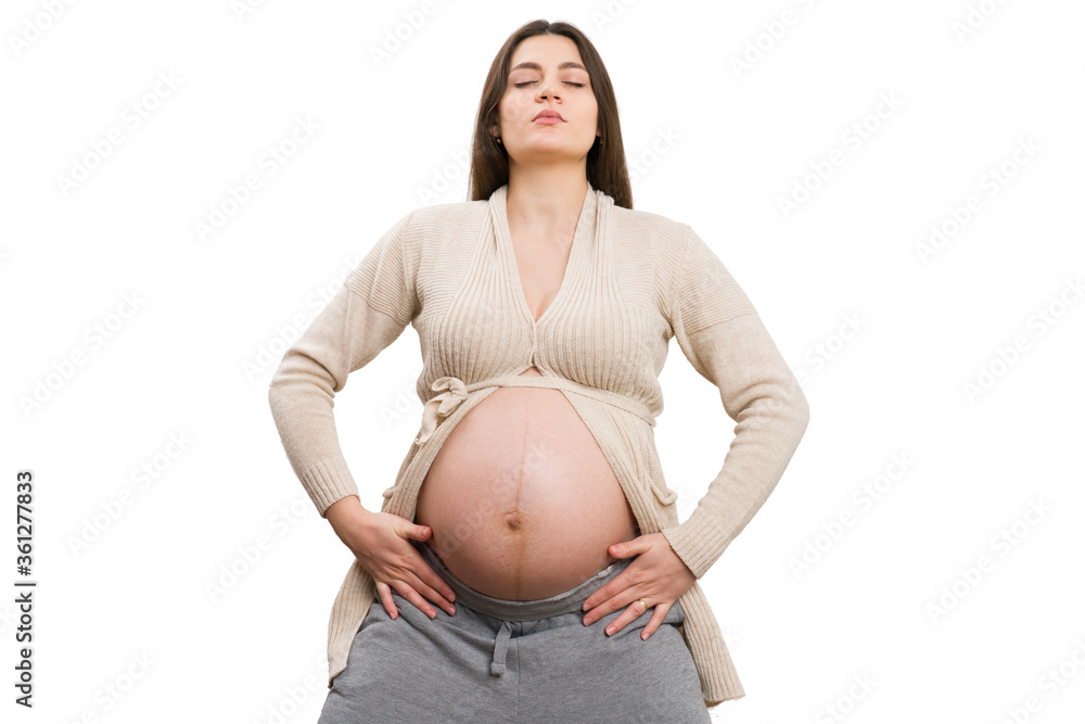 Pregnant woman concentrating on yoga position Pregnant woman concentrating on yoga position