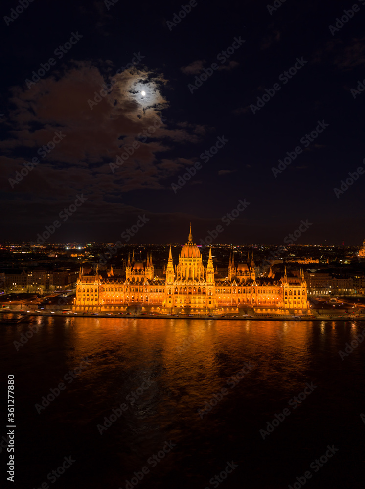 Aerial drone shot of Hungarian Parliament with lights on during Budapest evening