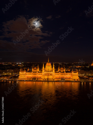 Aerial drone shot of Hungarian Parliament with lights on during Budapest evening © Davidzfr