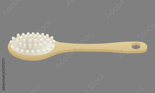 Brosse de massage pour le dos avec un grand manche en bois.