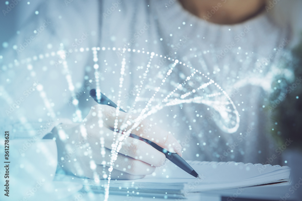 Obraz premium DNA theme hologram over woman's hands writing background. Concept of education. Double exposure