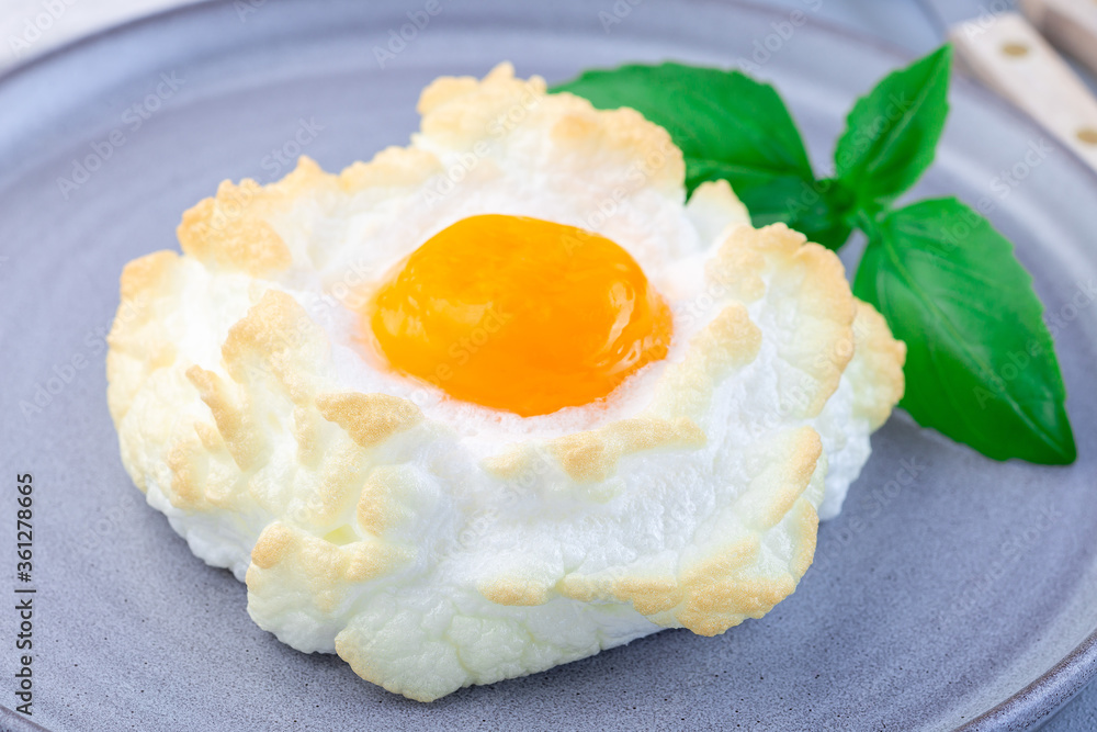 Oven baked cloud or fluffy egg dish on gray plate, horizontal, closeup