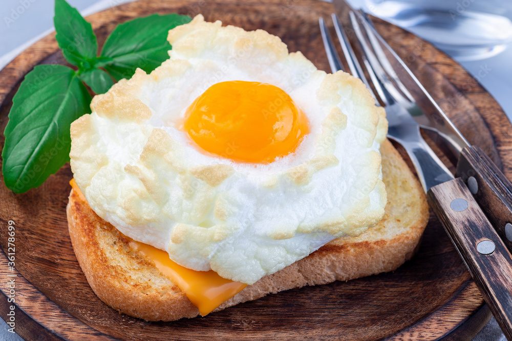 Trendy cloud or fluffy egg dish on a wooden plate, horizontal Trendy cloud or fluffy egg dish on a wooden plate, horizontal