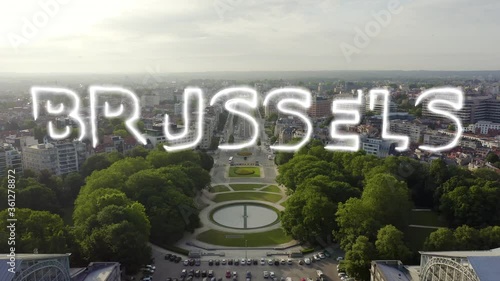 Inscription on video. Brussels, Belgium. Park of the Fiftieth Anniversary. Park Senkantoner. The Arc de Triomphe of Brussels (Brussels Gate). Neon white effect text, Aerial View, Departure of the cam photo