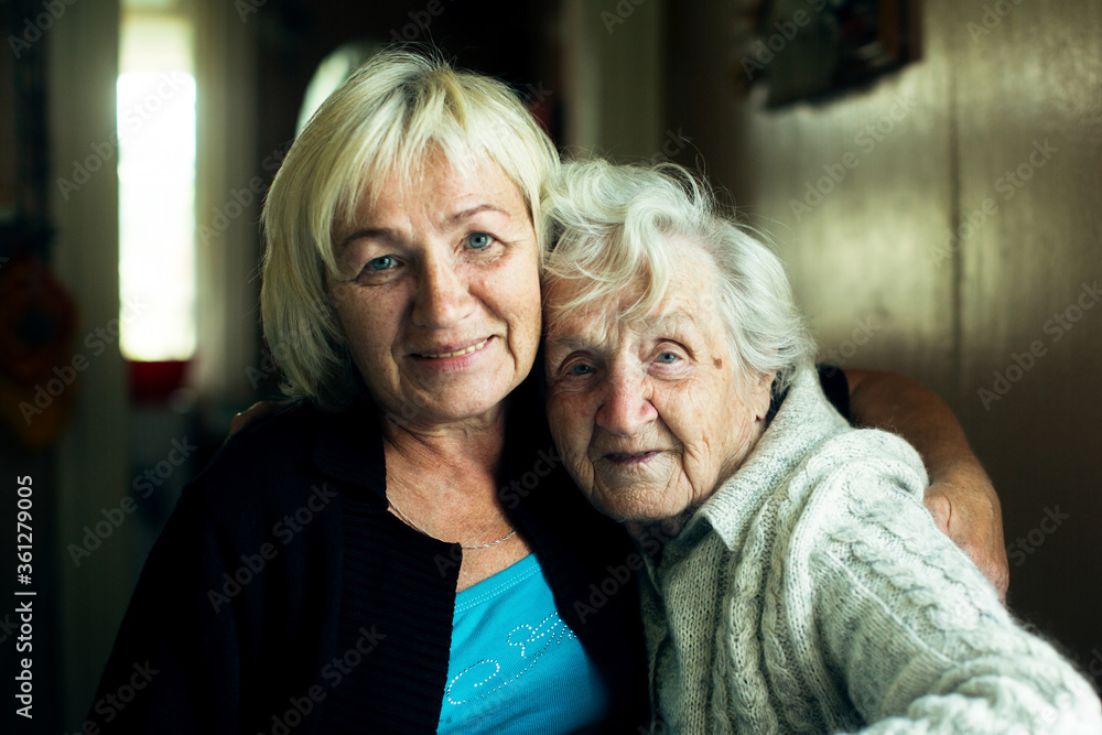 Portrait of mature woman together with her old mother. Portrait of mature woman together with her old mother.