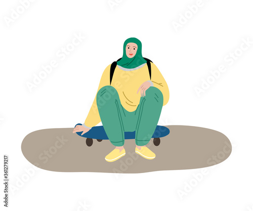 Young smiling muslim woman in hijab and sport clothing sitting on skateboard