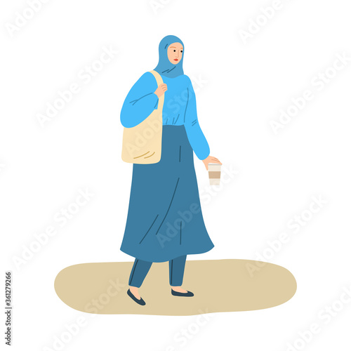 Young smiling muslim woman in hijab and traditional costume walking with coffee