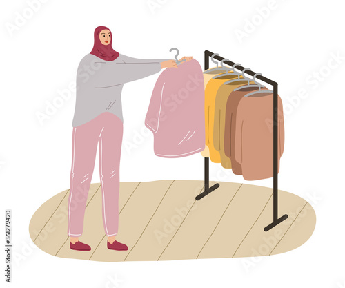 Young muslim woman in hijab and casual clothing doing shopping
