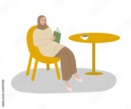 Young muslim woman in hijab and casual clothing reading book