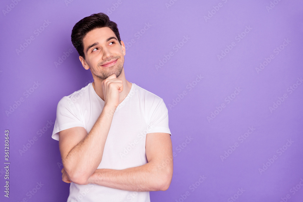 Photo of attractive handsome guy good mood arm on chin dreamer look interested empty space intelligent creative person wear casual white t-shirt isolated purple pastel color background Photo of attractive handsome guy good mood arm on chin dreamer look interested empty space intelligent creative person wear casual white t-shirt isolated purple pastel color background